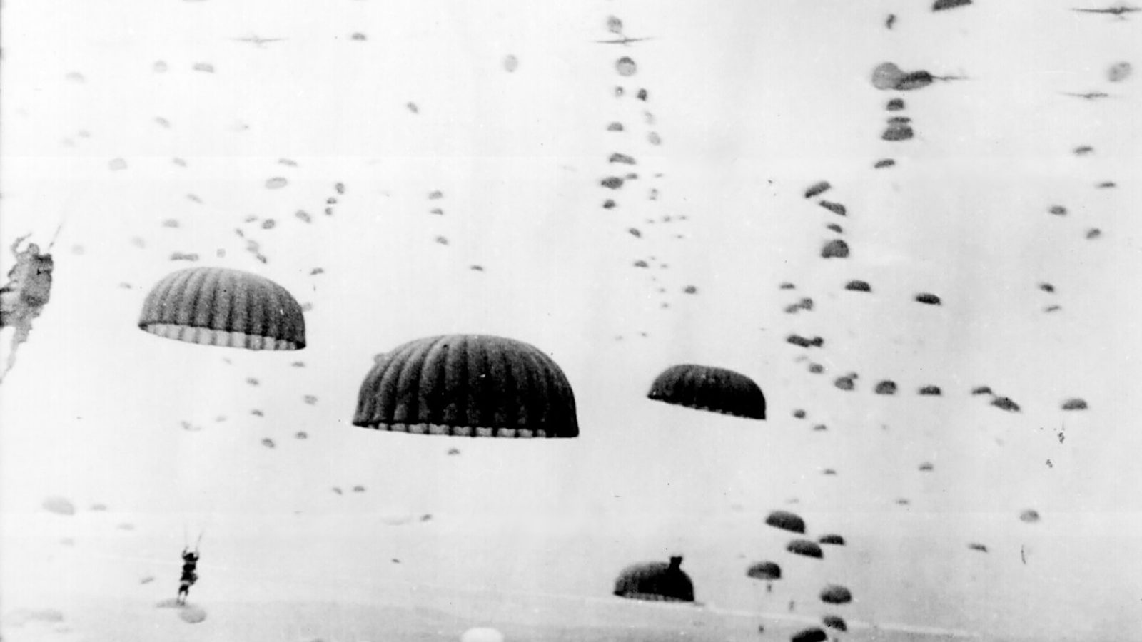 Allied paratroopers descending over the flat Dutch countryside during Operation Market Garden in September 1944