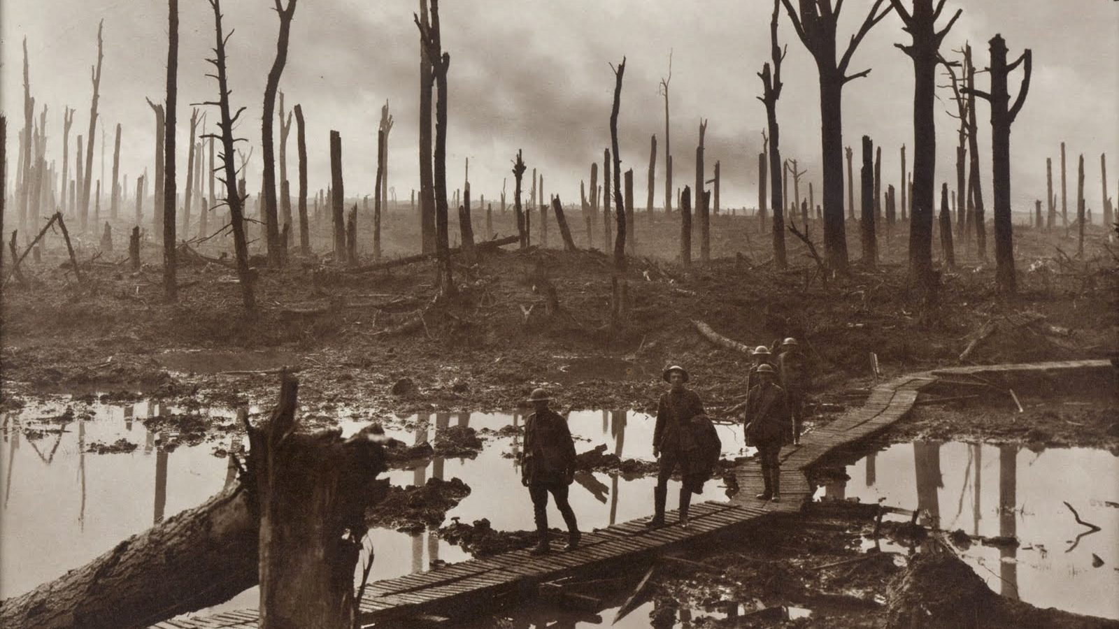 Wooden duckboards crossing a waterlogged, shell-cratered battlefield in Flanders during the Third Battle of Ypres in 1917